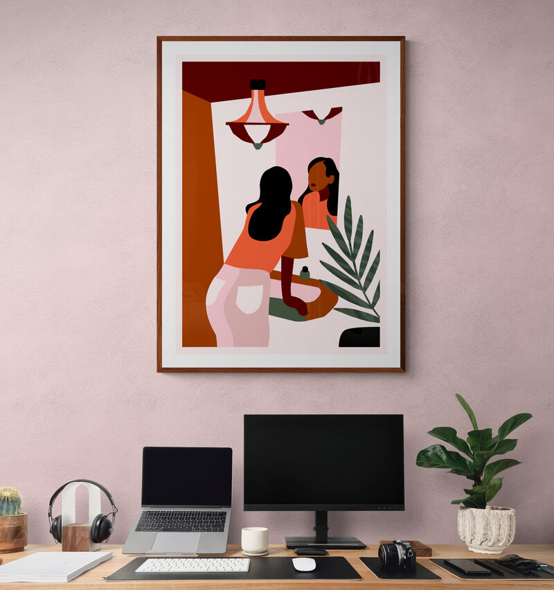 Figurative print above a desk with a laptop and monitor