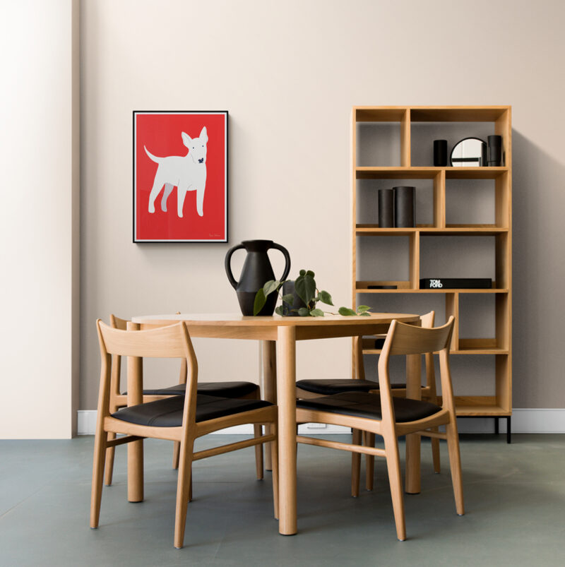 Red dog print in a dining room with pale timber furniture