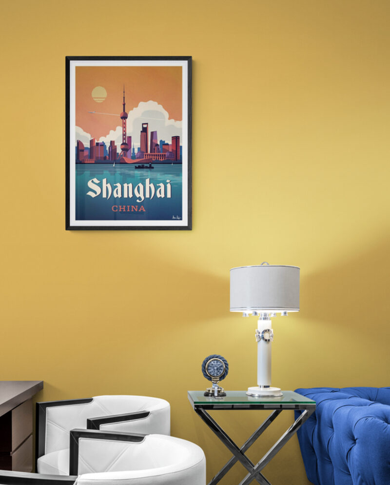 Hot air balloon print above a cream sofa beside an antique bureau